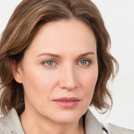 Joyful white young-adult female with medium  brown hair and blue eyes