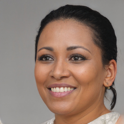 Joyful black young-adult female with medium  brown hair and brown eyes