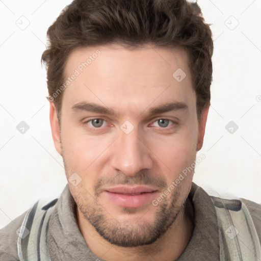 Joyful white young-adult male with short  brown hair and grey eyes