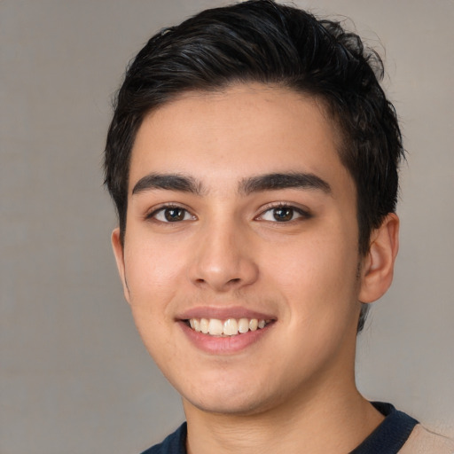 Joyful white young-adult male with short  black hair and brown eyes