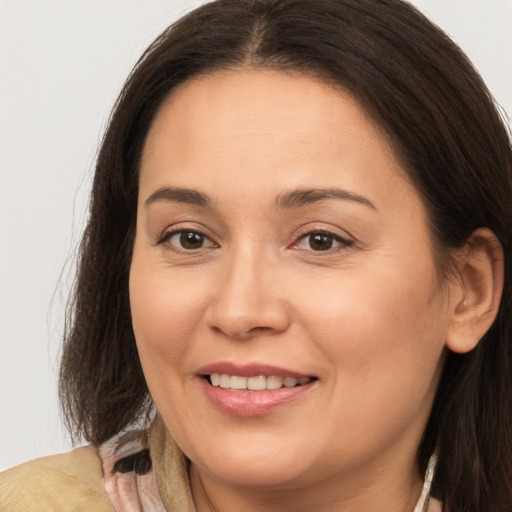 Joyful white young-adult female with long  brown hair and brown eyes