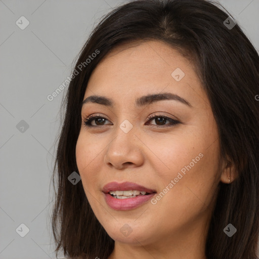 Joyful asian young-adult female with long  brown hair and brown eyes