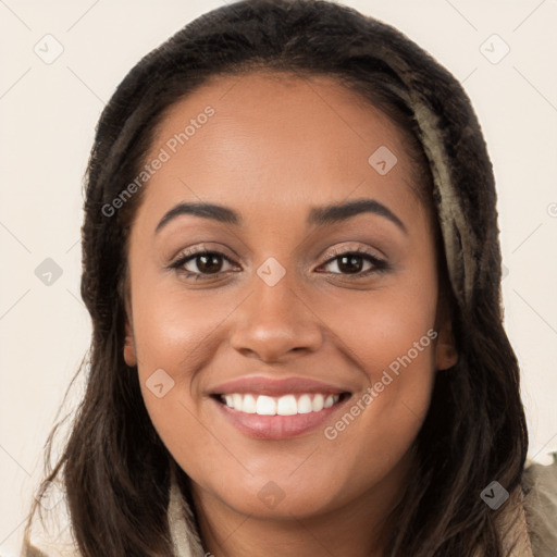 Joyful latino young-adult female with long  brown hair and brown eyes