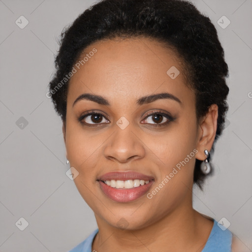 Joyful black young-adult female with long  black hair and brown eyes