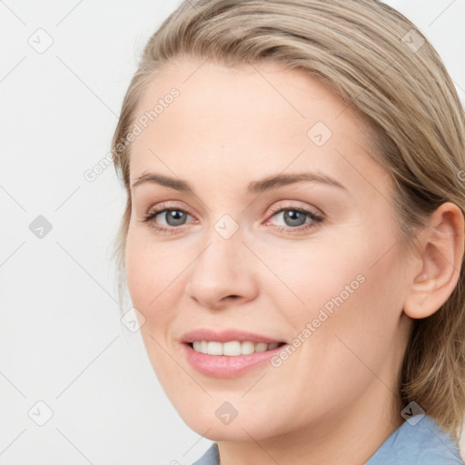 Joyful white young-adult female with medium  brown hair and blue eyes