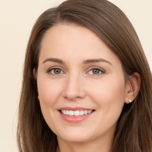 Joyful white young-adult female with long  brown hair and brown eyes