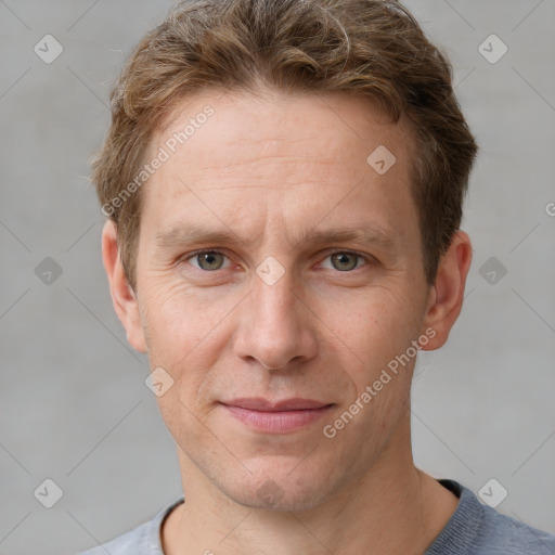 Joyful white adult male with short  brown hair and grey eyes