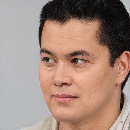 Joyful asian adult male with short  black hair and brown eyes