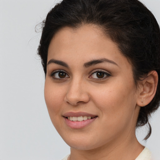 Joyful white young-adult female with medium  brown hair and brown eyes