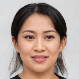 Joyful asian young-adult female with medium  brown hair and brown eyes