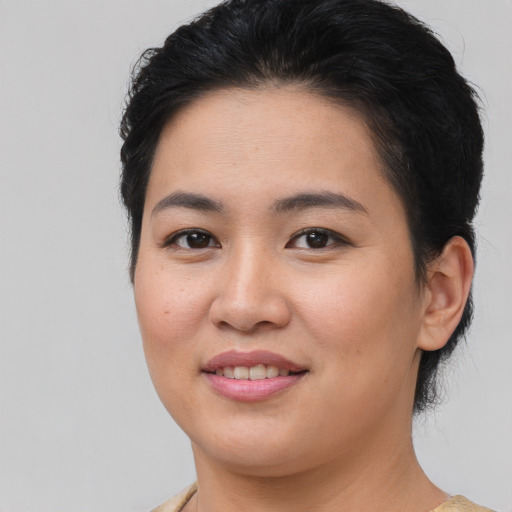 Joyful asian young-adult female with medium  brown hair and brown eyes