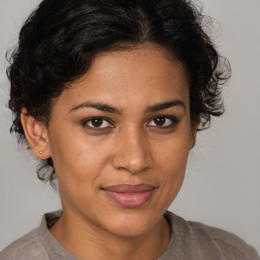 Joyful latino young-adult female with medium  brown hair and brown eyes