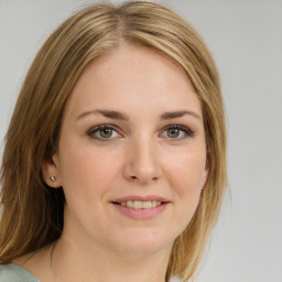 Joyful white young-adult female with medium  brown hair and green eyes