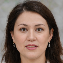 Joyful white adult female with long  brown hair and brown eyes