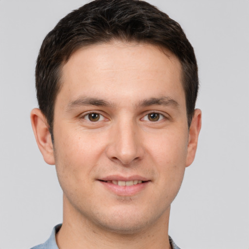 Joyful white young-adult male with short  brown hair and brown eyes