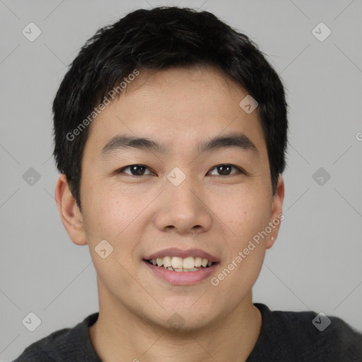 Joyful asian young-adult male with short  black hair and brown eyes