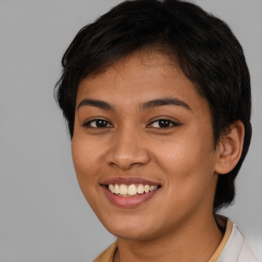 Joyful latino young-adult female with short  brown hair and brown eyes