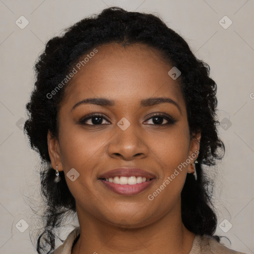 Joyful black young-adult female with long  brown hair and brown eyes