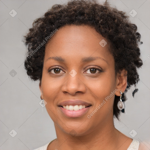 Joyful black young-adult female with short  brown hair and brown eyes