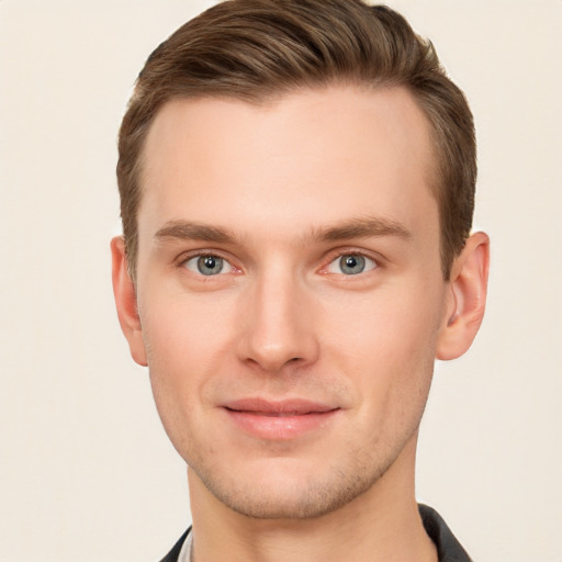 Joyful white young-adult male with short  brown hair and grey eyes