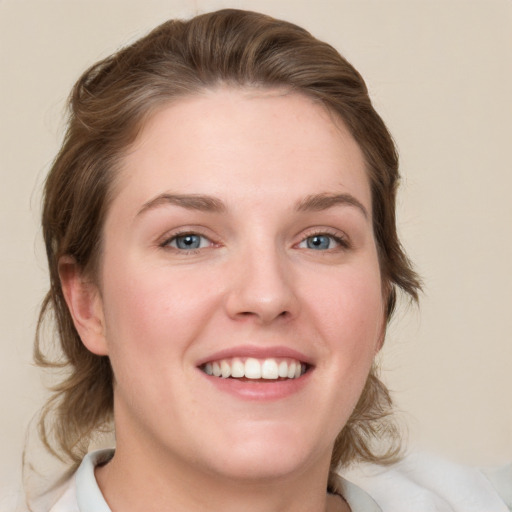 Joyful white young-adult female with medium  brown hair and blue eyes