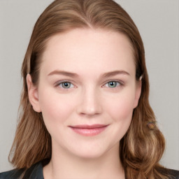 Joyful white young-adult female with long  brown hair and blue eyes