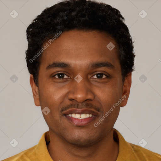 Joyful black young-adult male with short  black hair and brown eyes