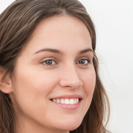 Joyful white young-adult female with long  brown hair and blue eyes