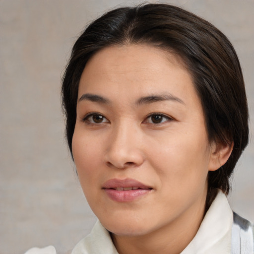Joyful asian young-adult female with medium  brown hair and brown eyes