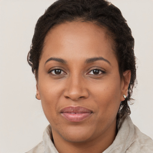 Joyful latino young-adult female with short  brown hair and brown eyes