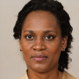 Joyful black adult female with medium  brown hair and brown eyes