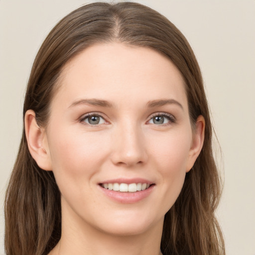 Joyful white young-adult female with long  brown hair and grey eyes