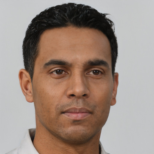 Neutral latino young-adult male with short  black hair and brown eyes