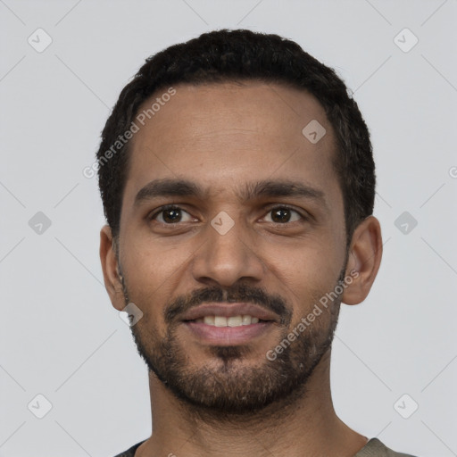 Joyful black young-adult male with short  black hair and brown eyes