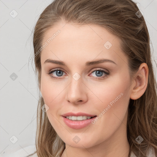 Joyful white young-adult female with long  brown hair and grey eyes