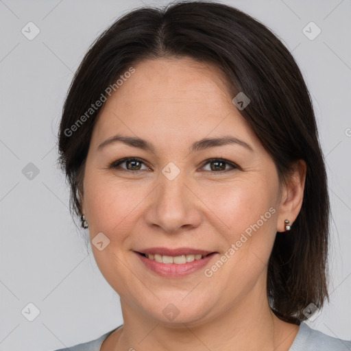 Joyful white adult female with medium  brown hair and brown eyes