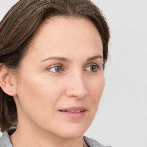 Joyful white young-adult female with medium  brown hair and blue eyes