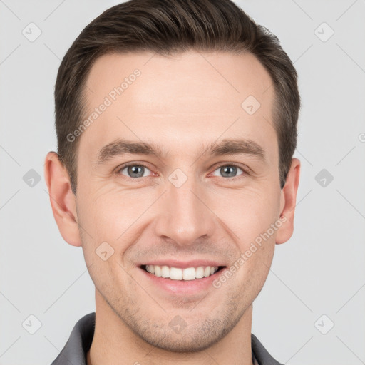 Joyful white young-adult male with short  brown hair and grey eyes