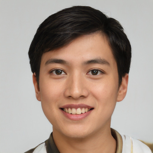 Joyful asian young-adult male with short  black hair and brown eyes