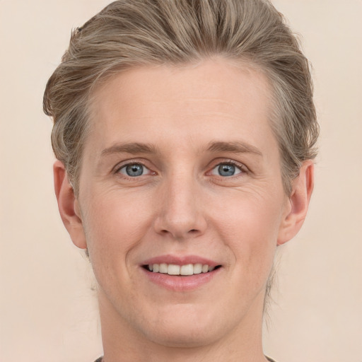 Joyful white young-adult male with medium  brown hair and grey eyes