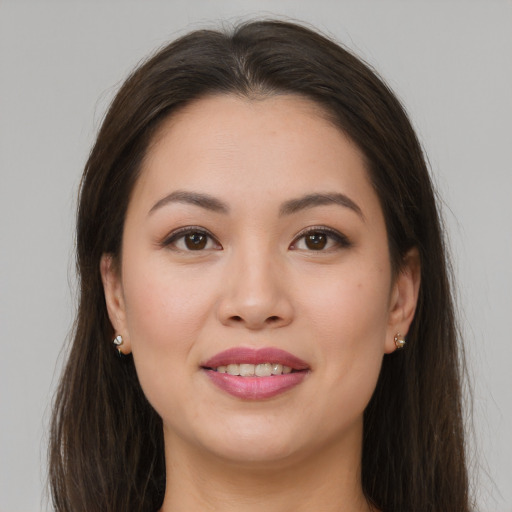 Joyful white young-adult female with long  brown hair and brown eyes