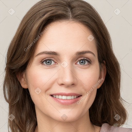 Joyful white young-adult female with medium  brown hair and green eyes