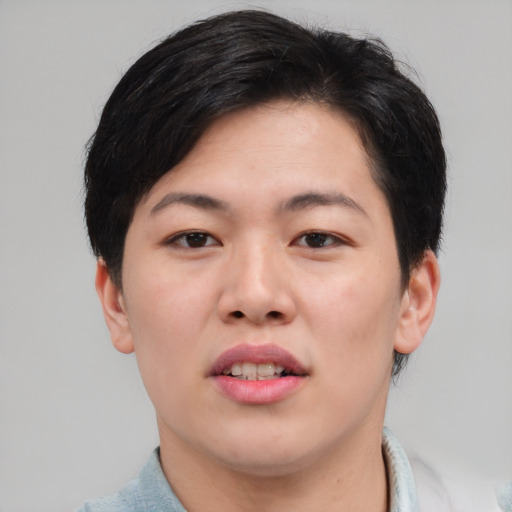 Joyful asian young-adult female with short  brown hair and brown eyes