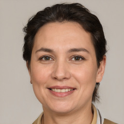 Joyful white adult female with medium  brown hair and brown eyes