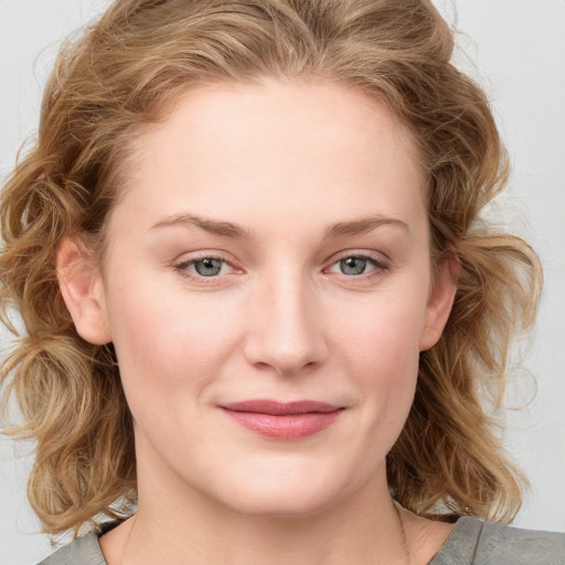 Joyful white young-adult female with medium  brown hair and blue eyes