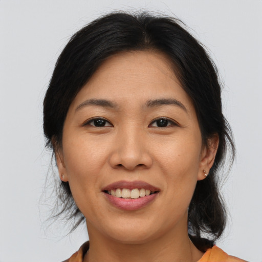 Joyful asian young-adult female with medium  brown hair and brown eyes