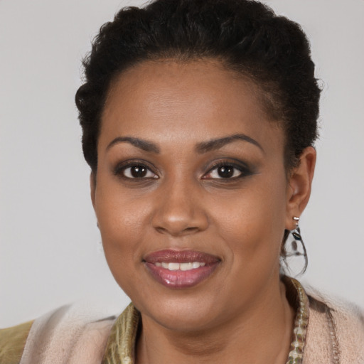 Joyful black young-adult female with short  brown hair and brown eyes