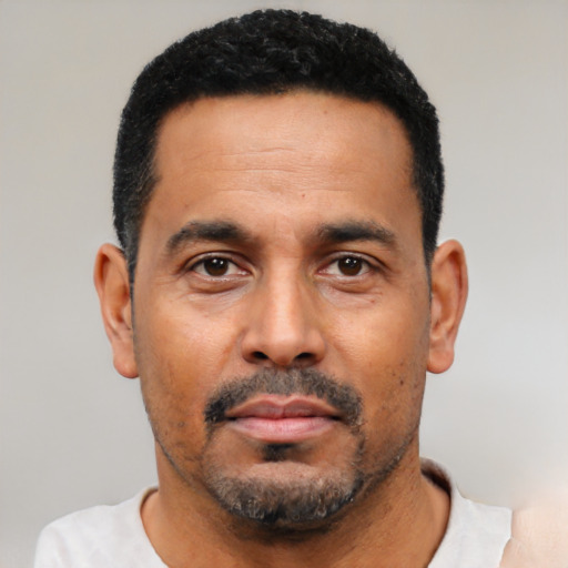 Neutral latino adult male with short  black hair and brown eyes