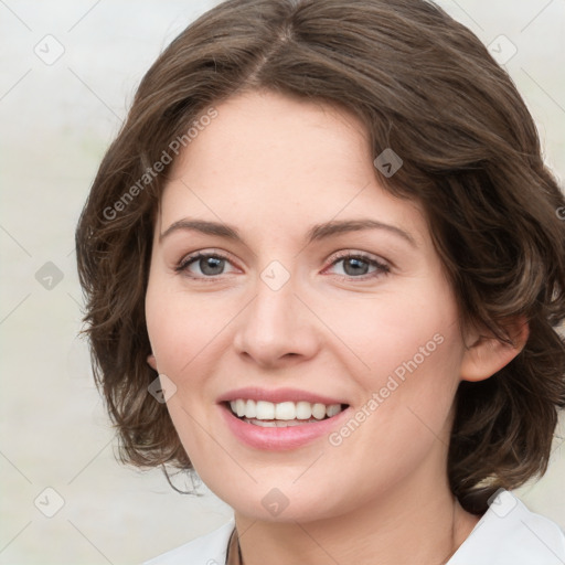 Joyful white young-adult female with medium  brown hair and green eyes