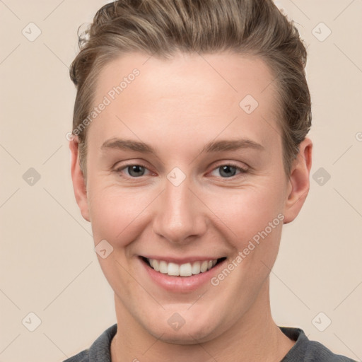 Joyful white young-adult female with short  brown hair and grey eyes